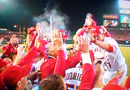 DCP02591.JPG: Erstad gets high-fives from his teammates after a solo home run bringing the Angels to within one.
